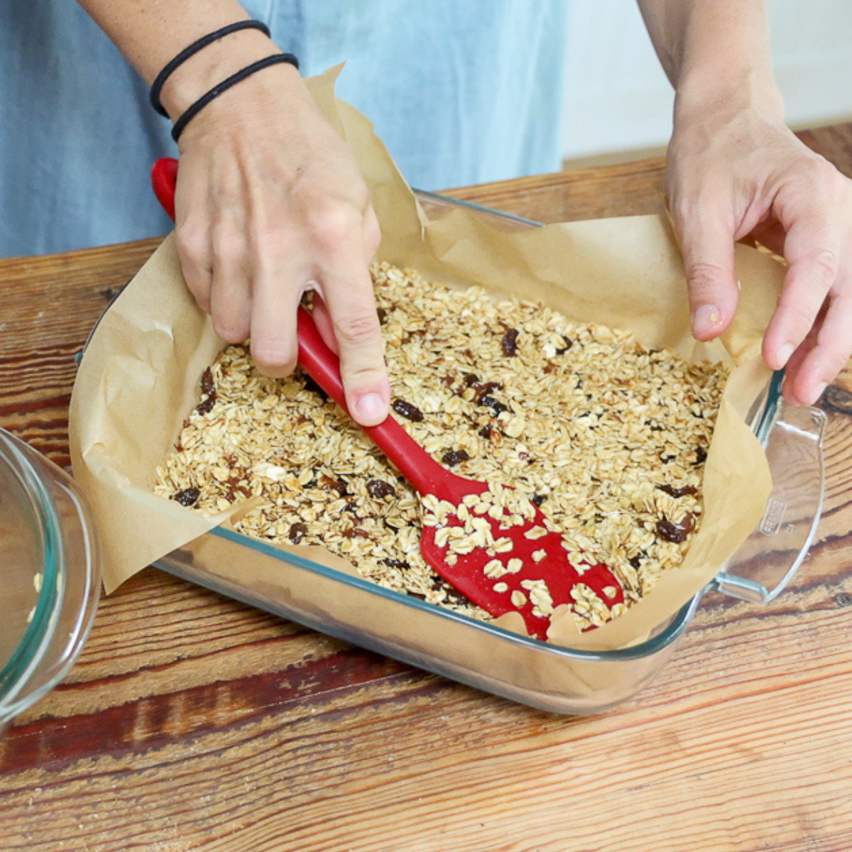pressing down mixture for homemade granola bars without peanut butter