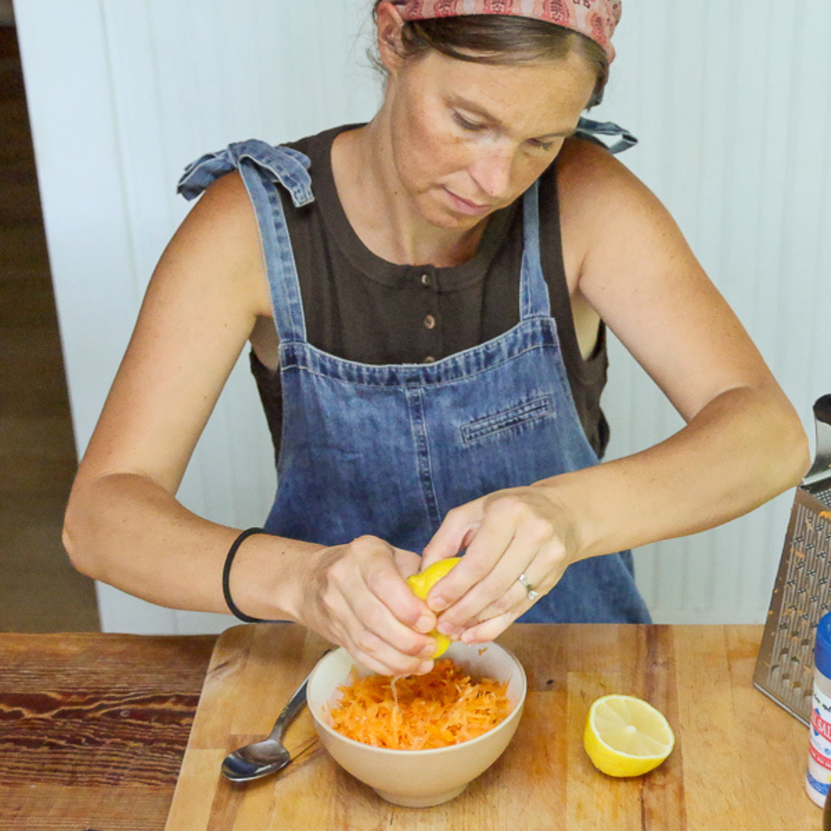 adding lemon juice to raw carrot salad