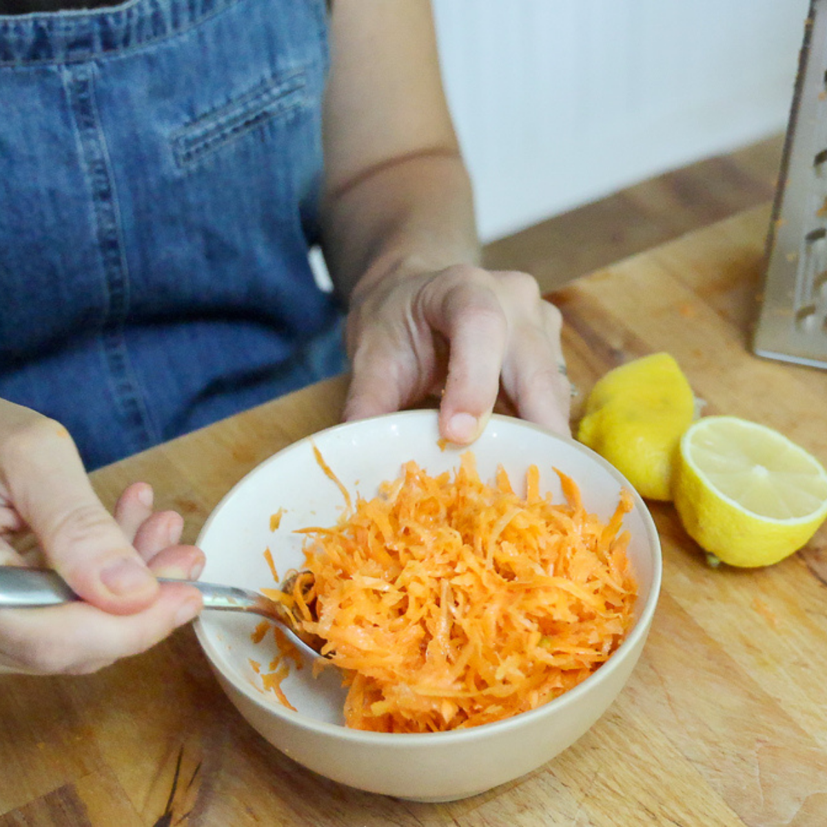 mixing raw carrot salad
